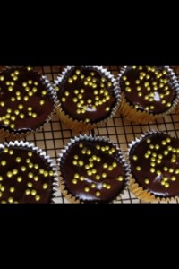 Ganache dipped cupcakes with a sparkly addition of gold dragee balls.