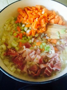 Sautéing the bacon, onions, carrots and celery. 