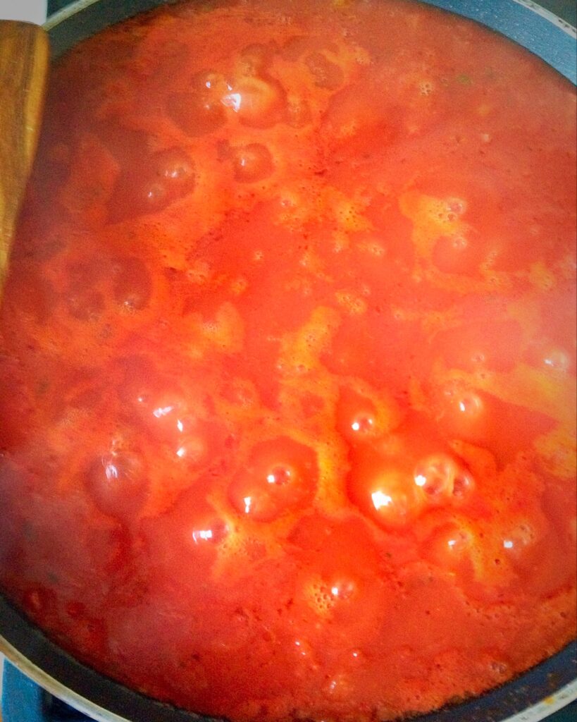 Tomato sauce in a pan cooking.