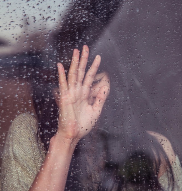 FF Woman behind rainy window
