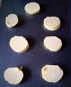 Place the uncooked Lemon Shortbread Cookies onto a non stick baking tray and sprinkle with sugar.