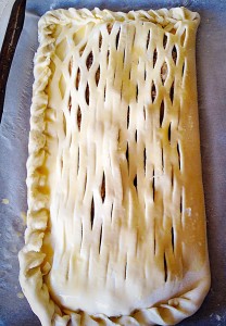 I have crimped the pastry edges by twisting them together, then brushed egg wash over the top of the Sausage Plait.