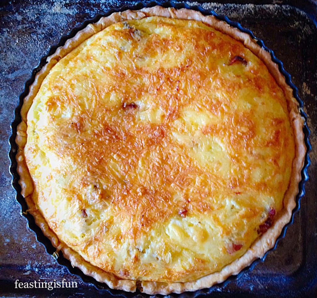Quiche Lorraine a classic recipe using sharp cheddar, gammon or bacon in a shortcrust pastry egg tart.