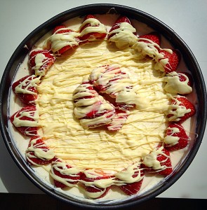 Continue drizzling until your White Chocolate Strawberry Cheesecake is complete.