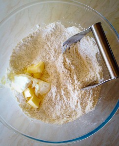 Add the butter and shortening, use a pastry cutter, or your fingers to work the fat into the flour. 
