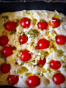 Sprinkle the thyme and garlic over the top and give your dough a final drizzle with Olive oil.