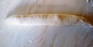 Roll each piece of dough out to just under the length of your baguette tray.