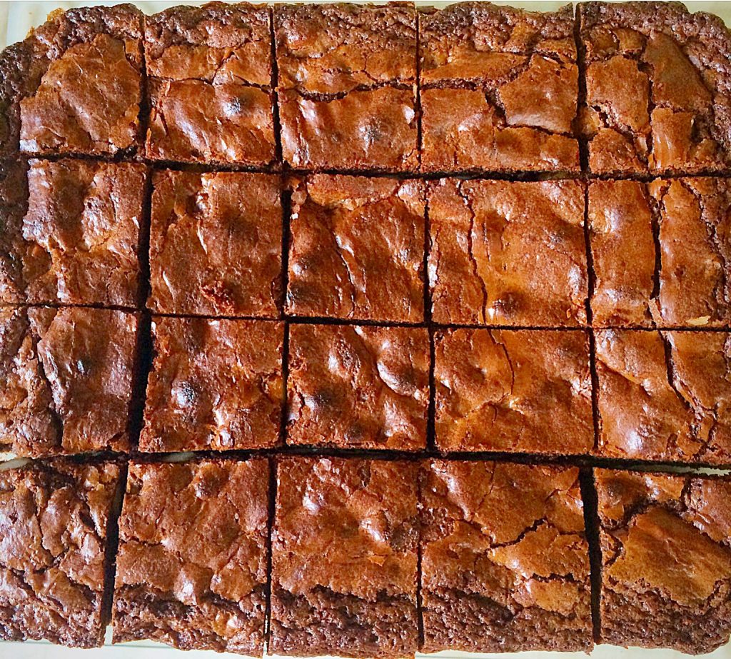 Chocolate macadamia nut brownies cut into squares.