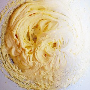 Whisked butter sugar salt and vanilla extract form the basis of the cupcakes batter.