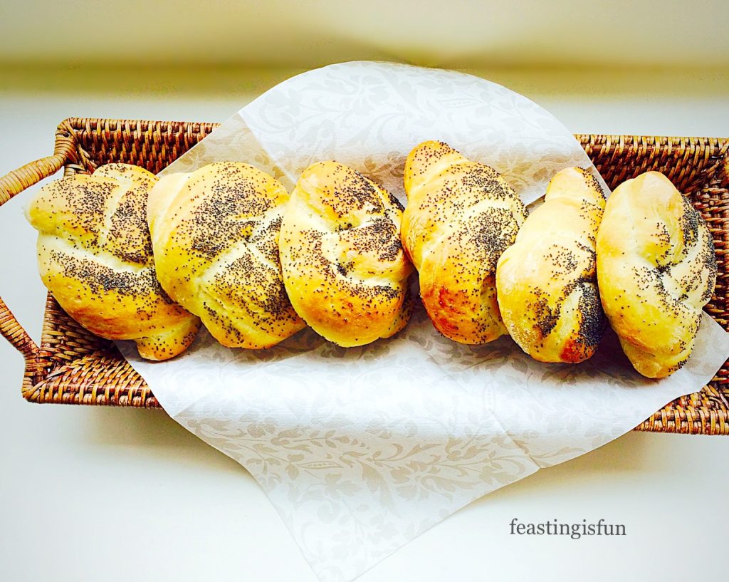 Crusty, white, seed topped individual small baked breads.