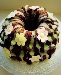 Lime Coconut Blossom Bundt Cake place the flowers onto the cake, dabbing the base of each one with glaze to hold it. Then get sprinkling with glitter! www.feastingisfun.com