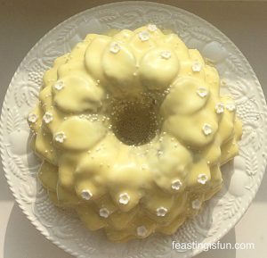 Lemon and blueberry cake baked in the blossom bundt pan from Nordicware. Covered in a fresh lemon glaze and decorated with small white sugar paste flowers.
