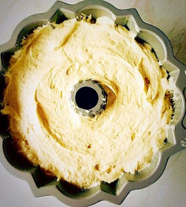 Cover the lemon curd with the other half of the cake batter, ensuring you do not fill the Bundt ton more than 3/4 full.