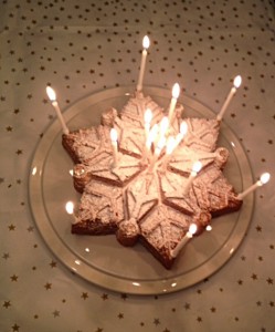 Spending Snowflake Cake stunning with candles www.feastingisfun.com