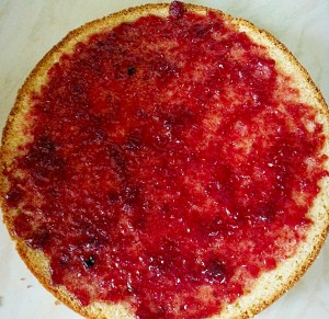 Spread the raspberry jam over one half of the sponge.