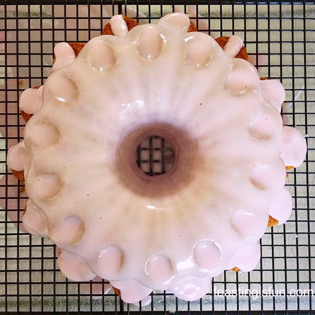 Decorating a Bundt cake with glacé icing.