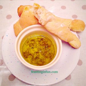 Breadsticks with garlic and herb dipping oil.