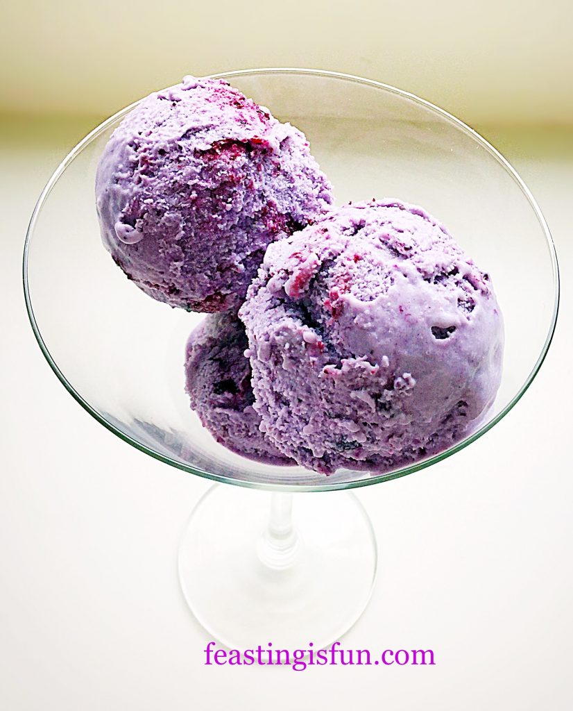 Scoops of Blueberry Bloom Ice Cream in a martini glass.
