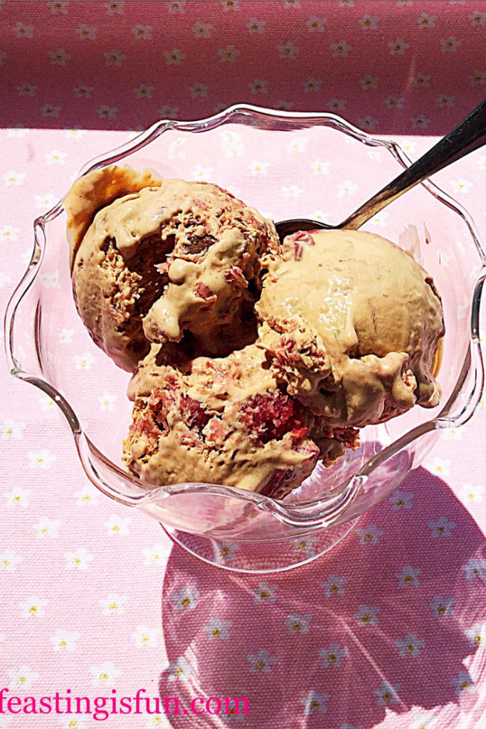 Scoops of flavoured ice cream in a bowl with a spoon.
