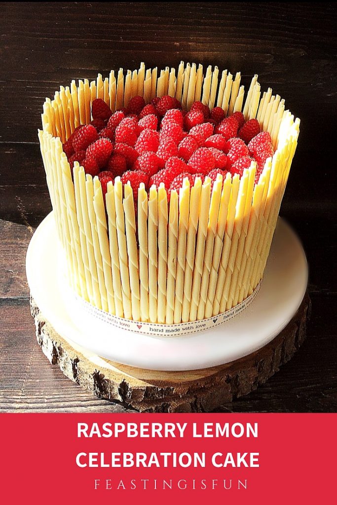 A white chocolate pencil surrounded, fresh fruit filled three sponge dessert. Ideal for parties and celebrating.