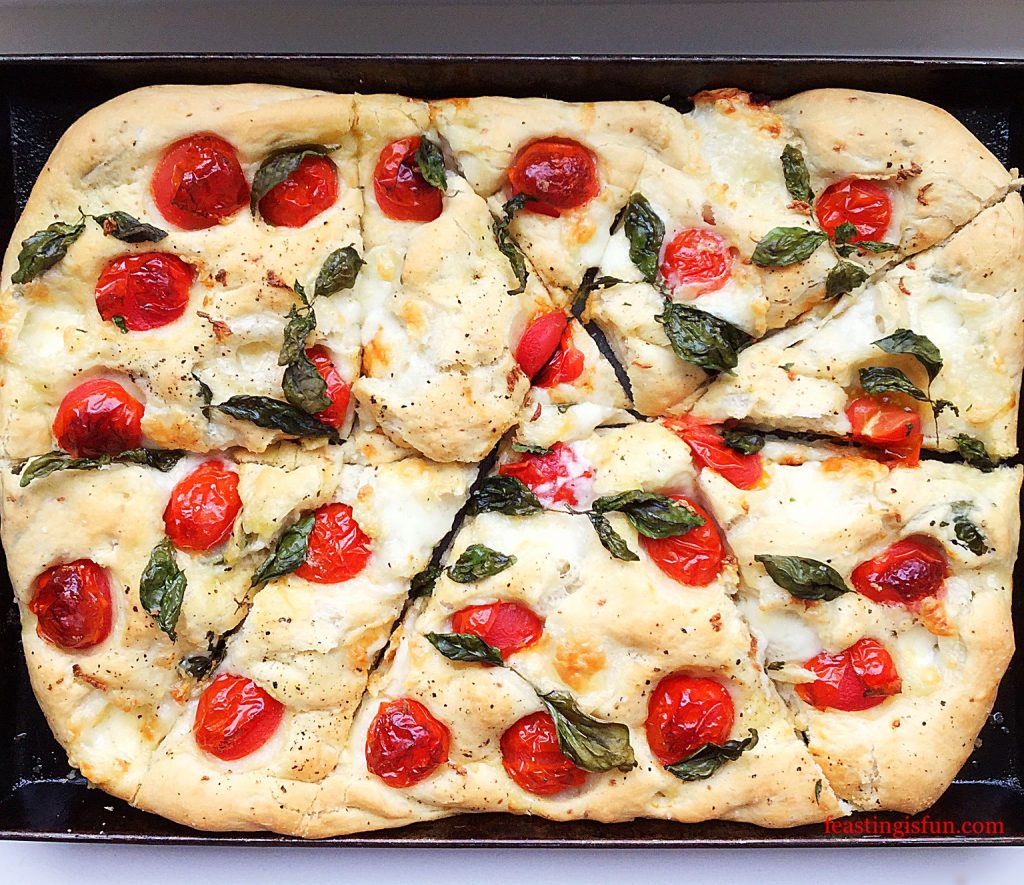 A pizza wheel is used to divide the Italian bread into portions for serving.