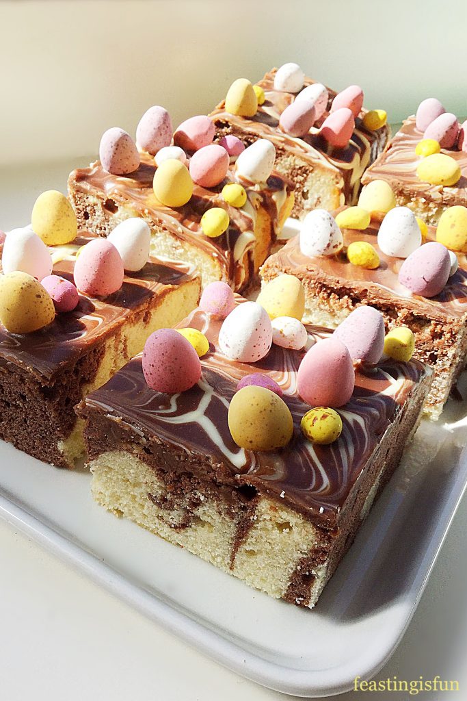 Easter chocolate and vanilla marbled traybake cake, topped with Cadbury’s mini eggs.