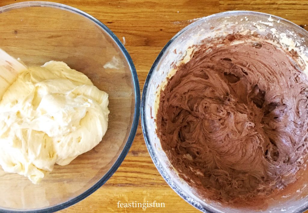 Two cake batters, chocolate and vanilla for creating a marble cake.