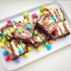 Brownies topped with bright, colourful mini eggs and a white chocolate drizzle.